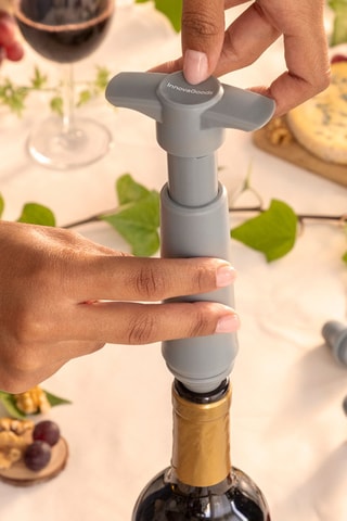 Tire-bouchon à pompe et 4 bouchons de vin