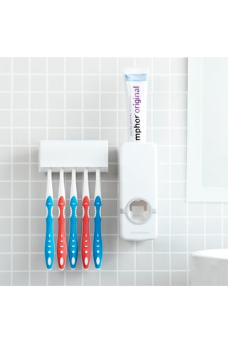 Distributeur de dentifrice avec porte-brosse à dents