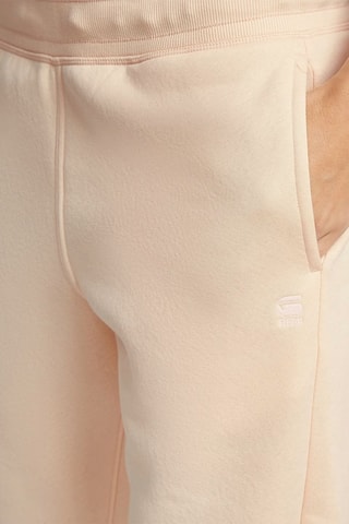 Calças de treino tapered em algodão biológico Premium Core - Rosa