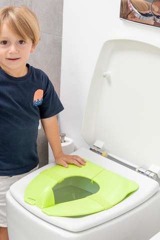 Sedile riduttore pieghevole per WC