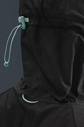 Coupe-vent de running à capuche Stride - Noir et turquoise